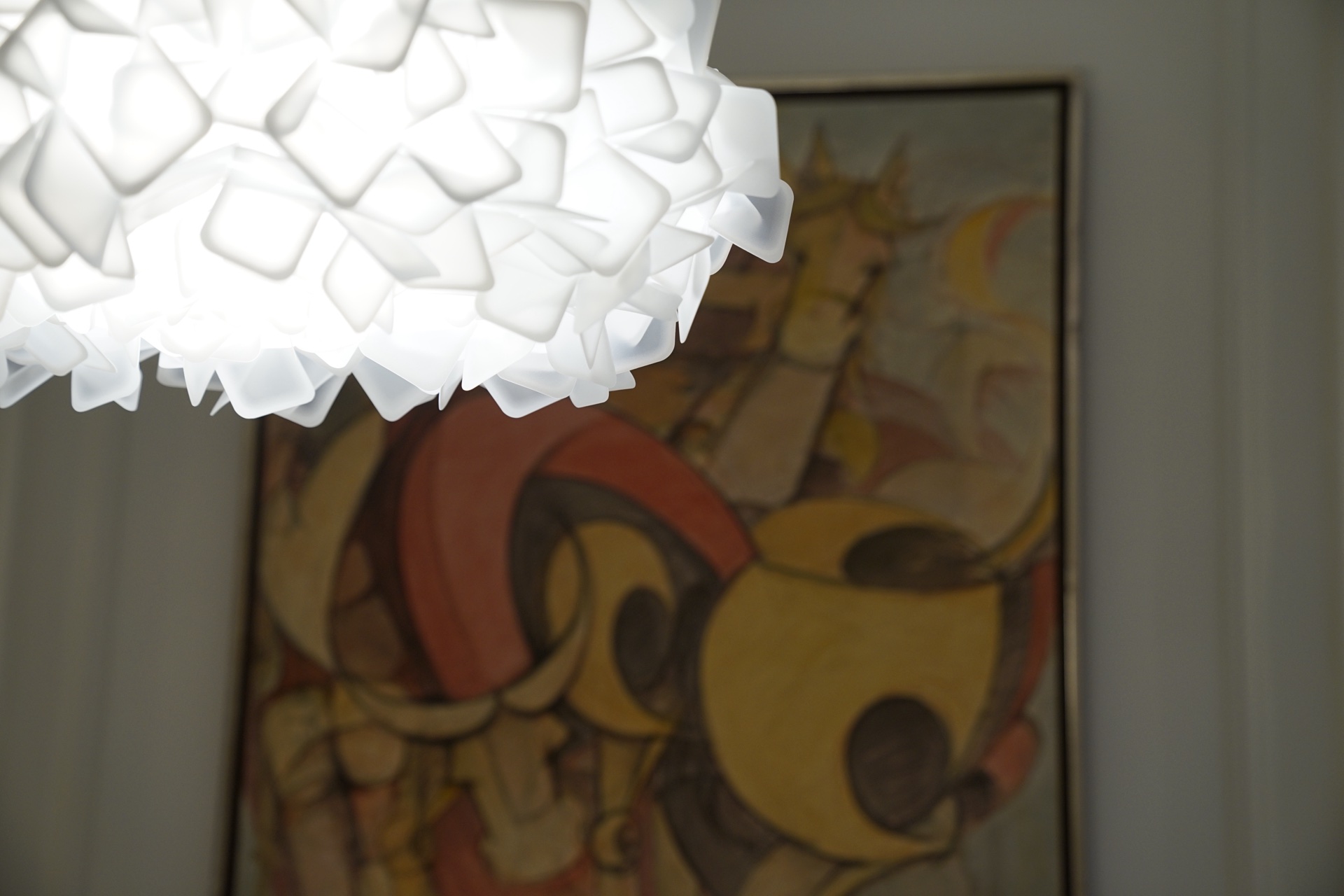 Dettaglio sala riunioni · lampada Slamp Clizia in primo piano con quadro figurativo sullo sfondo